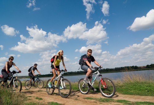 Family biking by lake